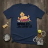 Spoiled and Loving It t-shirt design featuring a crowned golden retriever on a pillow, with dog accessories