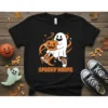 Spooky Hoops t-shirt design with a cartoon ghost holding a jack-o'-lantern and basketball sneakers