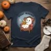 Spooky Mornings Latte Ghost T-Shirt with a cute ghost sitting in a chair holding a latte, perfect for Halloween coffee