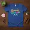Spread Kindness t-shirt with colorful text and hands forming a heart graphic