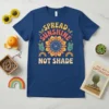 Spread Sunshine Not Shade retro graphic t-shirt with peace signs, rainbows, and butterflies