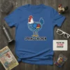 Blue t-shirt with a cartoon chicken made of coiled springs, text "SPRING CHICKEN" below, and a small card saying "YOU'RE
