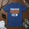 Squash Mode On text design with an on/off toggle graphic, featuring white and orange lettering on a blue t-shirt