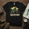 Squatchin t-shirt design with Bigfoot illustration on a mountain landscape, perfect for Sasquatch hunters