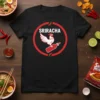 Black t-shirt with "Sriracha" text, a white chicken, and a red hot sauce bottle within a red circle