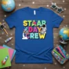 STAAR DAY CREW text with astronaut and rocket graphic on a blue t-shirt, perfect for teachers