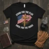 Black t-shirt with "Stand For The Flag Kneel For The Cross" text, American flag, and wooden cross graphic