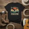 Black t-shirt with "STAPLETON" text above a vintage eagle, mountains, and bull skull graphic
