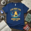 Graphic t-shirt design featuring "STAR NIGHT COW ABUCTION EST. 1888" with a cow being abducted by a UFO