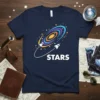 Navy t-shirt with the word STARS in white, above a colorful swirling galaxy and two rockets