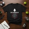 Black t-shirt with "STAY FOCUSED UP" text, a circuit board brain graphic, and motivational phrases like "Grind Hard" and "Earn