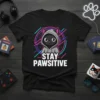 Stay Pawsitive t-shirt design with a black cat wearing a grey hoodie and neon geometric background