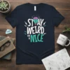 Stay Weird and Be Nice quote t-shirt with a lightbulb brain graphic in teal and pink