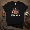 Black t-shirt with "STAY WILD" text and a sleeping fox graphic surrounded by trees and a moon