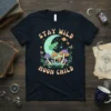 Stay Wild Moon Child t-shirt design with a green frog on a crescent moon, surrounded by colorful mushrooms and stars