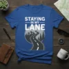 Blue t-shirt with white text "STAYING IN MY LANE" above a winding road graphic with mountains and trees