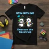 Black t-shirt with "Stim With Me Embrace The Spectrum" text and cartoon pandas wearing headphones and a rainbow scarf, holding