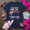 Navy blue t-shirt with white and red text "stop asking WHY I'M RAZY I DON'T ASK why you're so stupid"