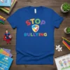 Blue t-shirt with colorful "STOP BULLYING" text and a peace dove emblem, promoting anti-bullying awareness
