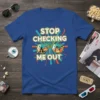 Stop Checking Me Out t-shirt design featuring bold white text over yellow sunglasses reflecting a crowd
