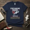 Navy blue t-shirt with white and gold text reading "STOP MAKING DRAMA YOU'RE NOT SHAKESPERE" and a theatre mask graphic