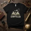 Storyteller t-shirt with an open book design, stars, and planets emanating from the pages