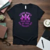 Feminist t-shirt with purple text "Strong Women Know Them Be Them Know Them Raise Them" and graphics of three women