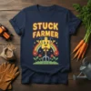 Retro graphic tee with "Stuck Farmer" text and a cartoon star character holding a pitchfork, with a rainbow and flowers
