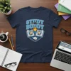 Study Buddy T-Shirt with cartoon owls holding a torch, books, and brain graphic
