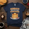 Sundays Are For Eating Pancakes text design with a stack of pancakes graphic on a navy t-shirt
