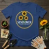 Sunflower Power & Growth text with three yellow sunflowers inside a yellow circle on a blue t-shirt