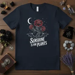 Gothic t-shirt design with the text "Sunshine Is For Plants" above red roses, a crescent moon, and bat wings