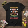 Sunshine and Lollipops text with a lollipop tree graphic on a black t-shirt, featuring colorful swirls and candy
