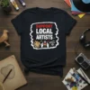 Black t-shirt with "SUPPORT LOCAL ARTISTS" text and graphics of art supplies, microphone, and film clapper
