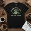 Support Your Local Coffee Shops text with a cute smiling coffee cup graphic and coffee beans on a black t-shirt