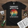 Support Your Local Tattoo Artist quote with vintage sunset graphic on a black t-shirt