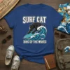 Surf Cat King Of The Waves T-Shirt design featuring a black panther surfing a blue wave, bold white text above