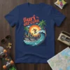Surf the streets t-shirt design with skateboarder on a city wave, palm trees, and sunset