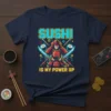 Sushi Is My Power Up text with samurai warrior holding swords and sushi rolls graphic on a navy t-shirt