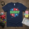 Navy blue t-shirt with the word SUSSY in green text, surrounded by red and blue character heads from the game