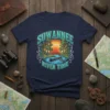Suwannee River Time t-shirt design featuring a canoe on a river at sunset with trees and decorative border