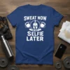 Sweat Now No Quit Selfie Later gym t-shirt featuring a Spartan helmet, kettlebells, and motivational text