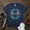 Sweat Now Shine Later quote with dumbbell graphic on navy blue t-shirt, fitness and gym motivation theme