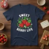 Sweet Berry Life text with three strawberries and green leaves graphic on a navy t-shirt