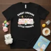 Sweet Dreams Little Friends t-shirt design with cute fluffy animals, macarons, and stars. White text and pastel graphics on black