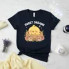 Sweet Dreams Z text with a sleeping chick in a nest, surrounded by flowers, on a navy t-shirt
