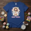Sweet Jesus! text and cartoon Jesus holding a lollipop on a blue t-shirt, surrounded by colorful candies