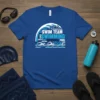 Blue t-shirt with 'SWIM TEAM SWIMMING' text art, featuring wave and swimmer graphics, keywords like lanes, race, pool, and splash