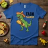 Taco Saurus T-Shirt featuring a green dinosaur wearing a sombrero and holding a taco, with "Taco Saurus" text