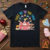 Take Me To The Fair text with Ferris wheel, carnival tent, and popcorn graphic on a black t-shirt